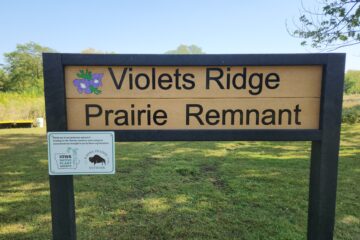 A large sign dedicating a named prairie remnant at Don Williams Park